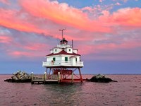 Thomas Point Shoal Lighthouse with pink and orange sky.