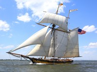 Pride of Baltimore II sailing with fully deployed sails on a clear day.
