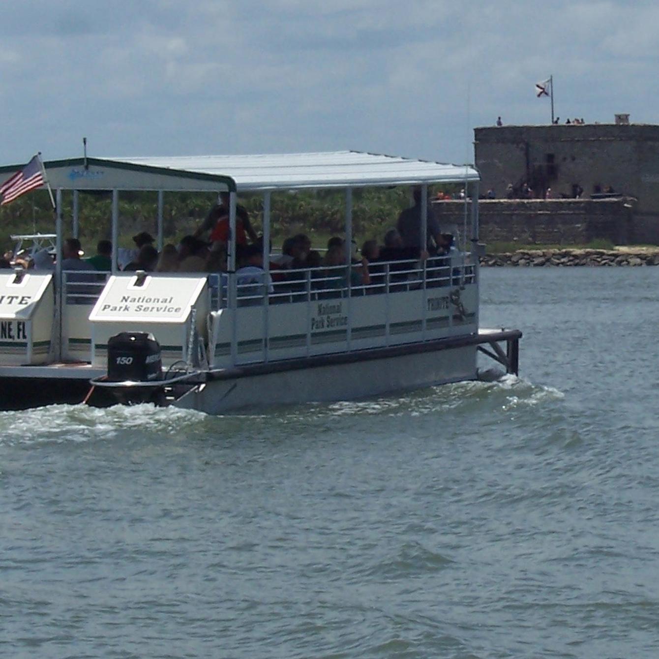 Ferry boat in the water with the Fort in the background
