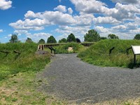 outdoors, photograph, grass, fort, cannon, gravel sign