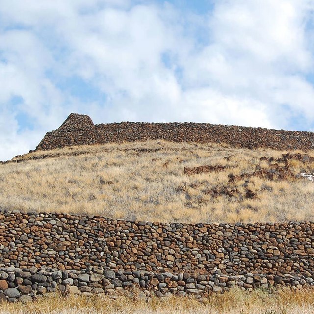 a brown colored, human made rock plateau viewed from below