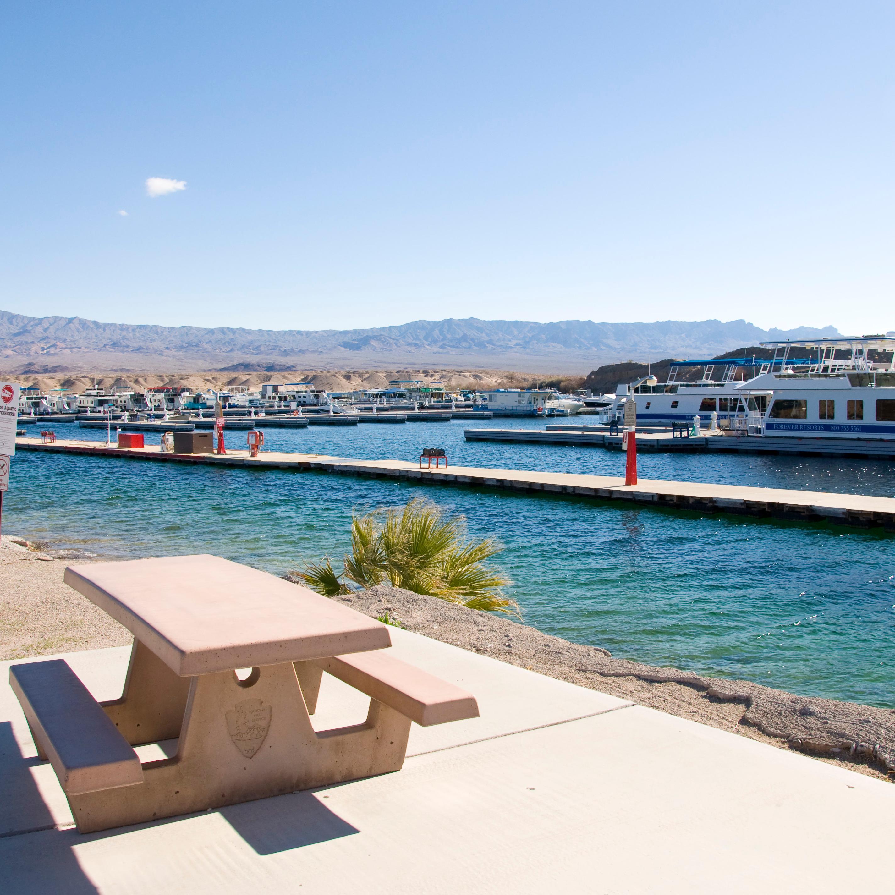 A picnic table next to a body of water