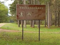 View of Yockanookany from Parkway. Brown and White color sign name location.