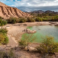 A cove next to a geologic formation.