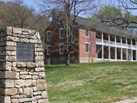The pillar and plague for Shawnee Indian Missions and one of the red brick buildings