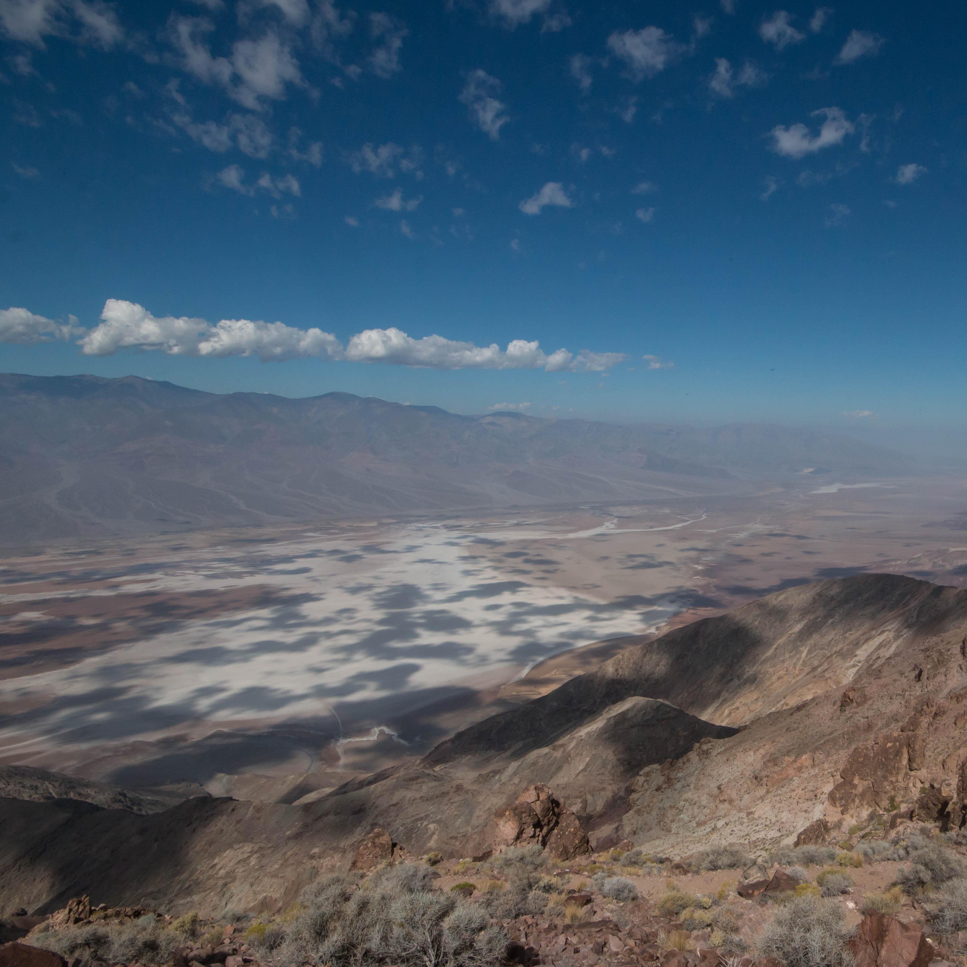An expansive view of a desert valley floor from a desert ridge. 