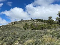 A low rise marks the summit of a nearby mountain.