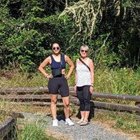 Two hikers along a gravel path