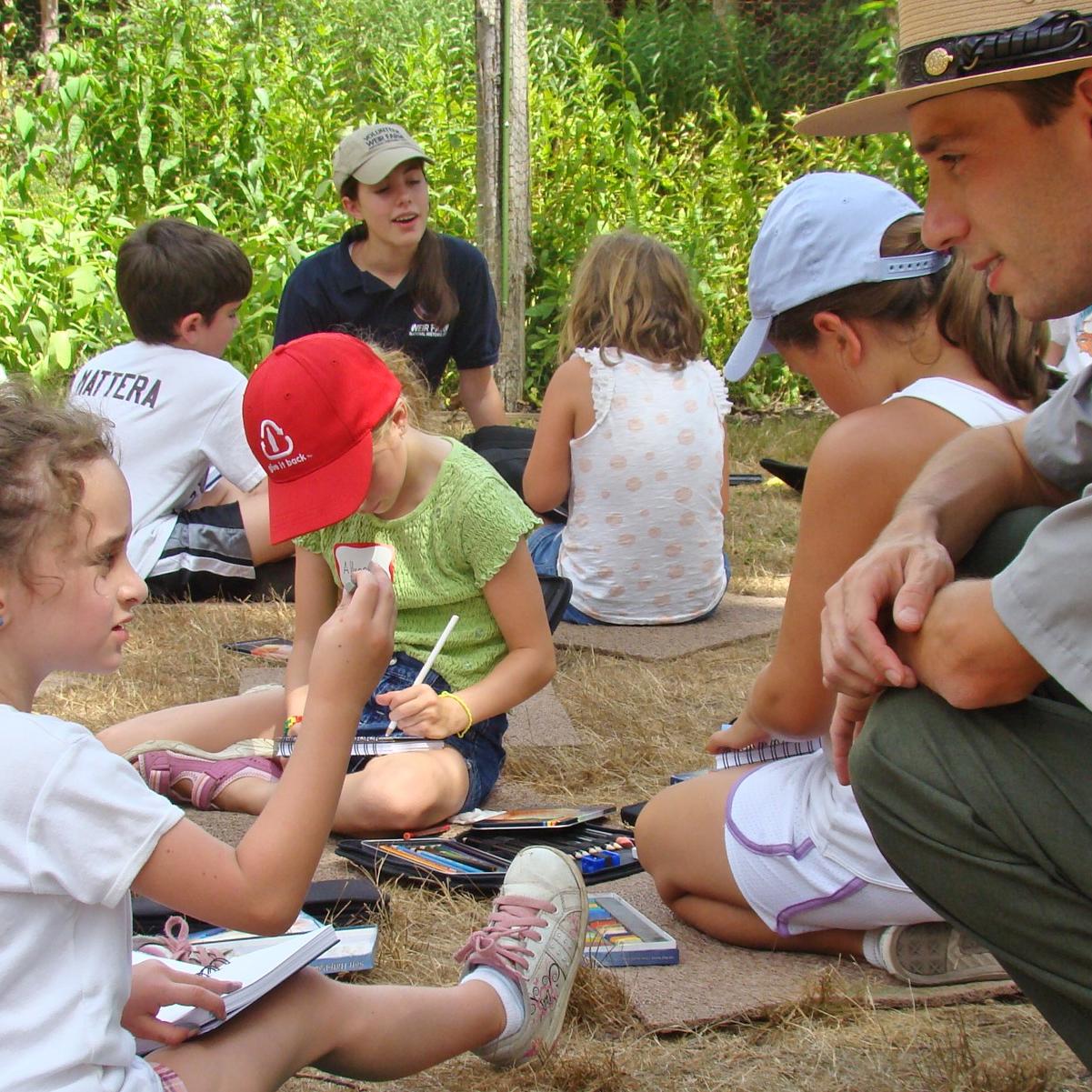 A young girl talking to a Park Ranger.