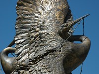 A metal statue of a crane