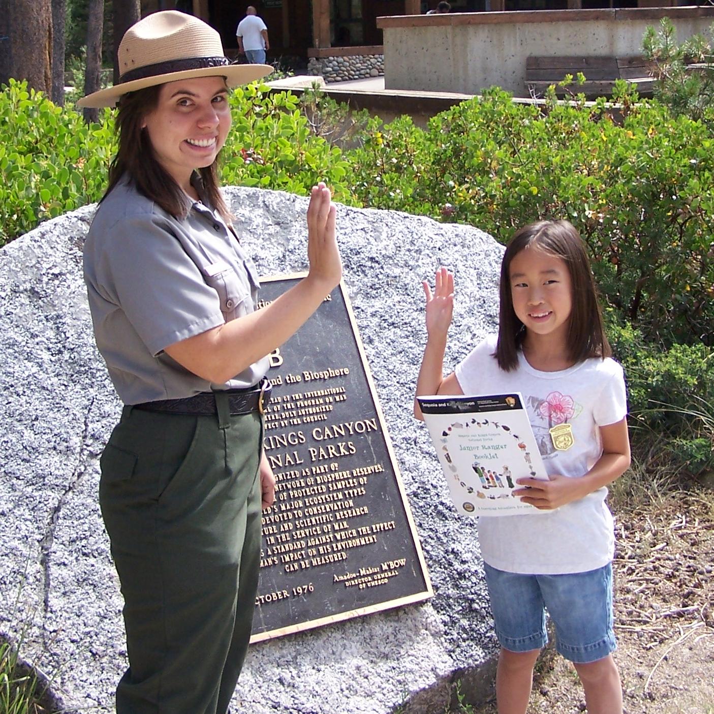 A ranger swears in a child as a Junior Ranger