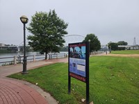 Pathway along the riverfront with Trail of Tears exhibit on the side and bridge in the background.