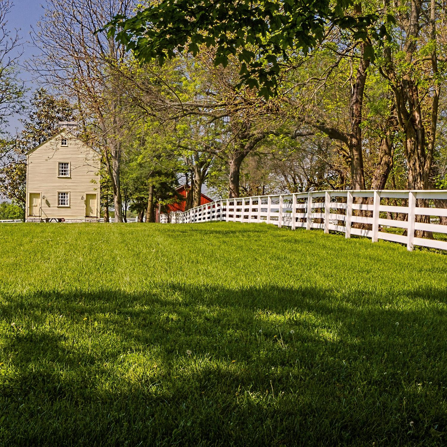 fence leading to a simple clapboard building