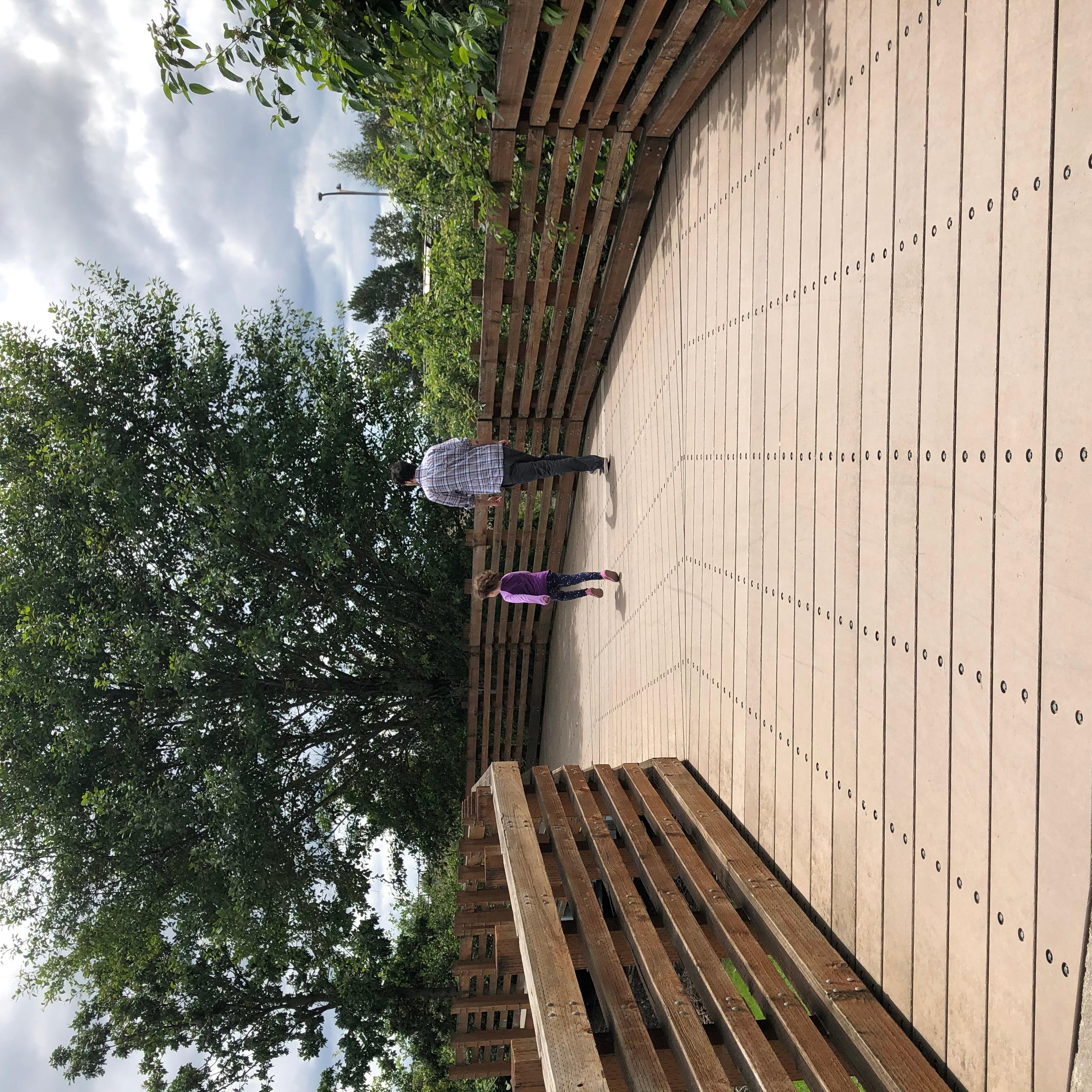 A man and child walk on a trail.