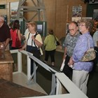Individuals look at exhibits in a museum.