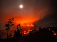 Molten lava within a crater at night.
