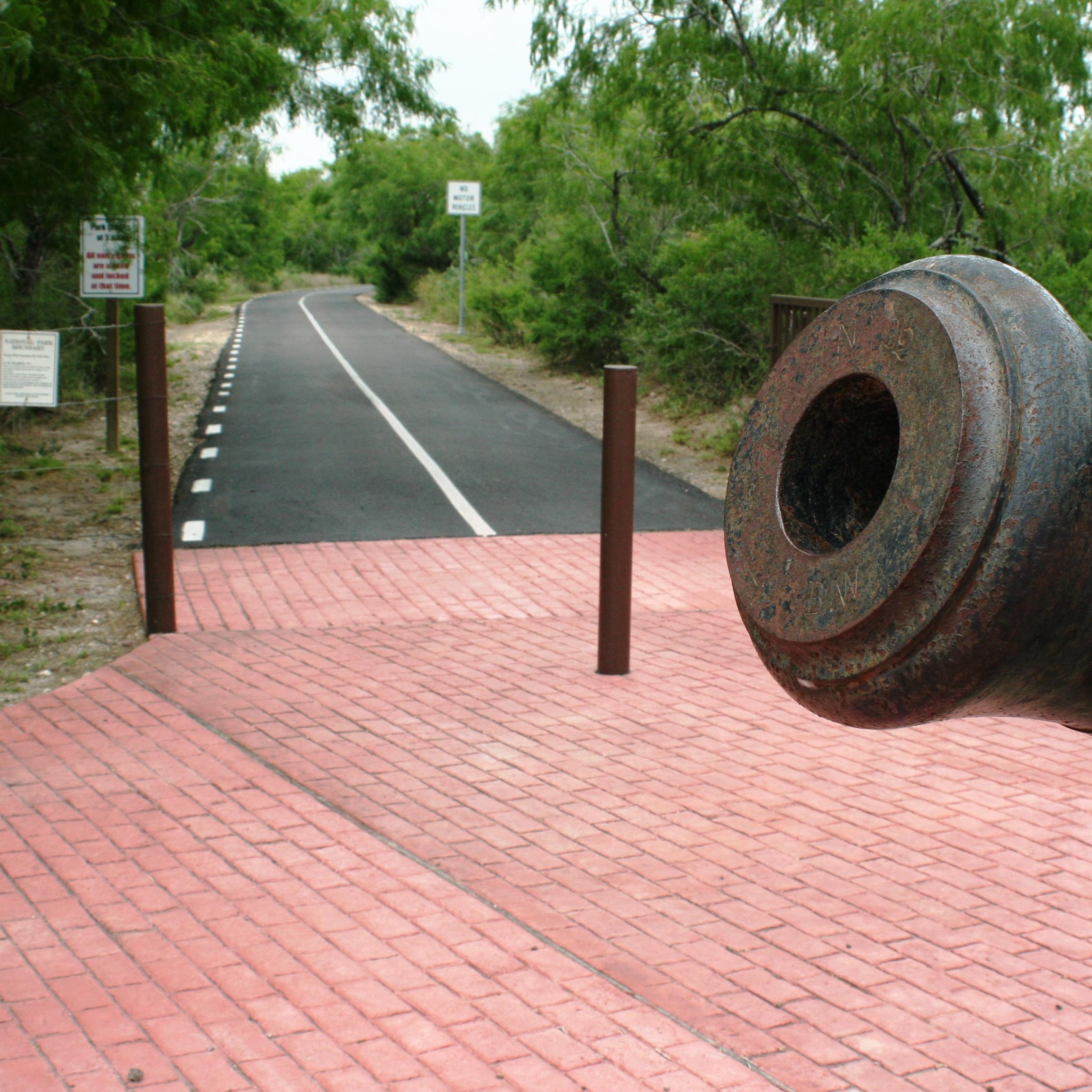 Cannon in foreground with hike and bike trail in background