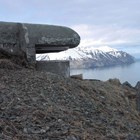 a concrete structure sticking out of a hill