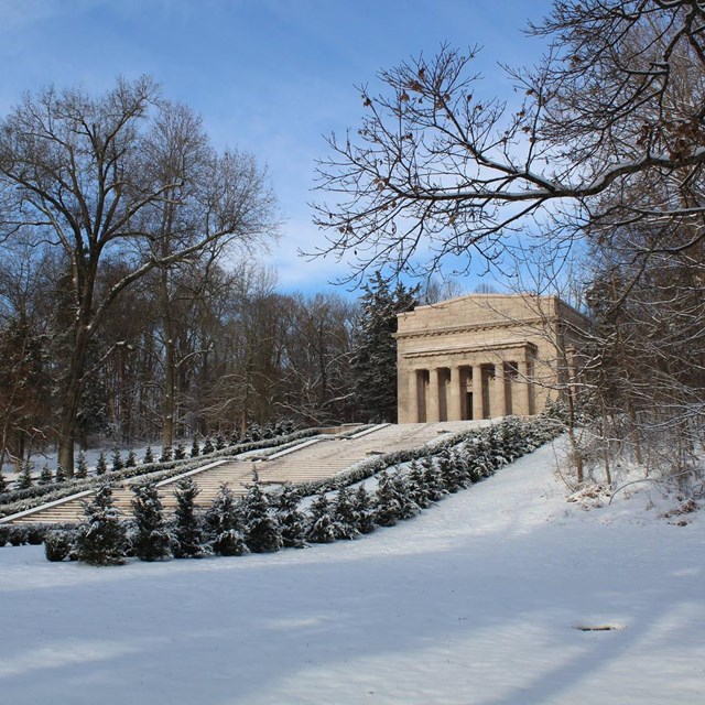 Classical-style temple memorial on top of a snow-covered hill
