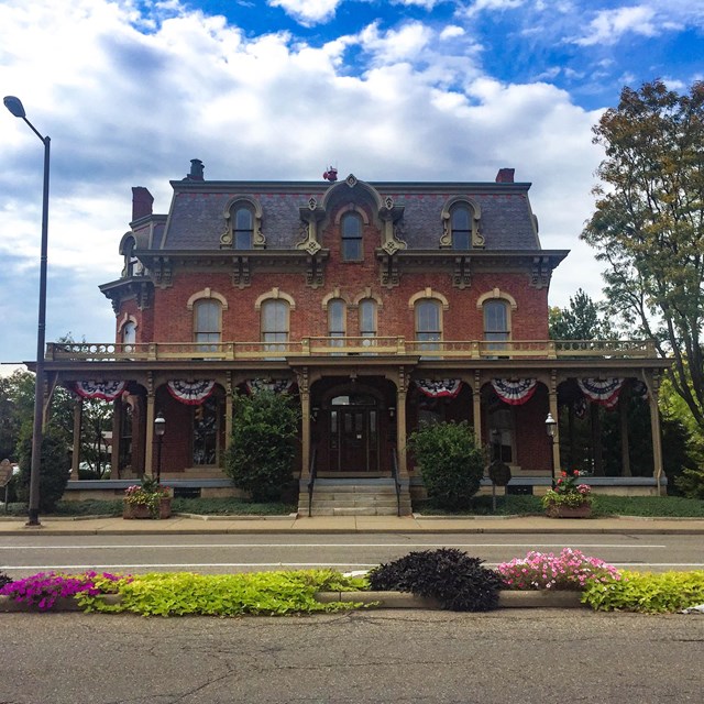 Two-story brick house on a town street