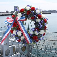 Wreath decorated in red, white, and blue flowers.