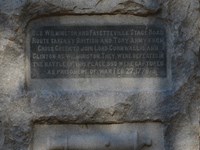 Small Stone Monument (about four feet high) with grassy field around it.