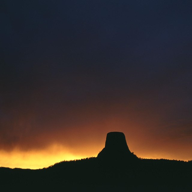 The Tower illuminated from the back by bright orange and yellow light.