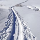 Ski trail winding across a snow-covered, hilly landscape.