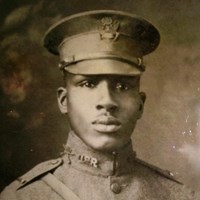 Black and white photo of African American man in WW1 military uniform