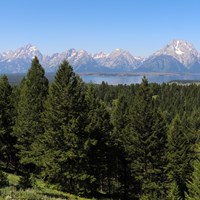 A mountain range and a lake as viewed from a high vantage point.