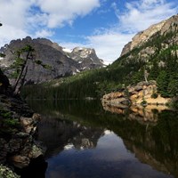 a mountain top is reflected in a lake