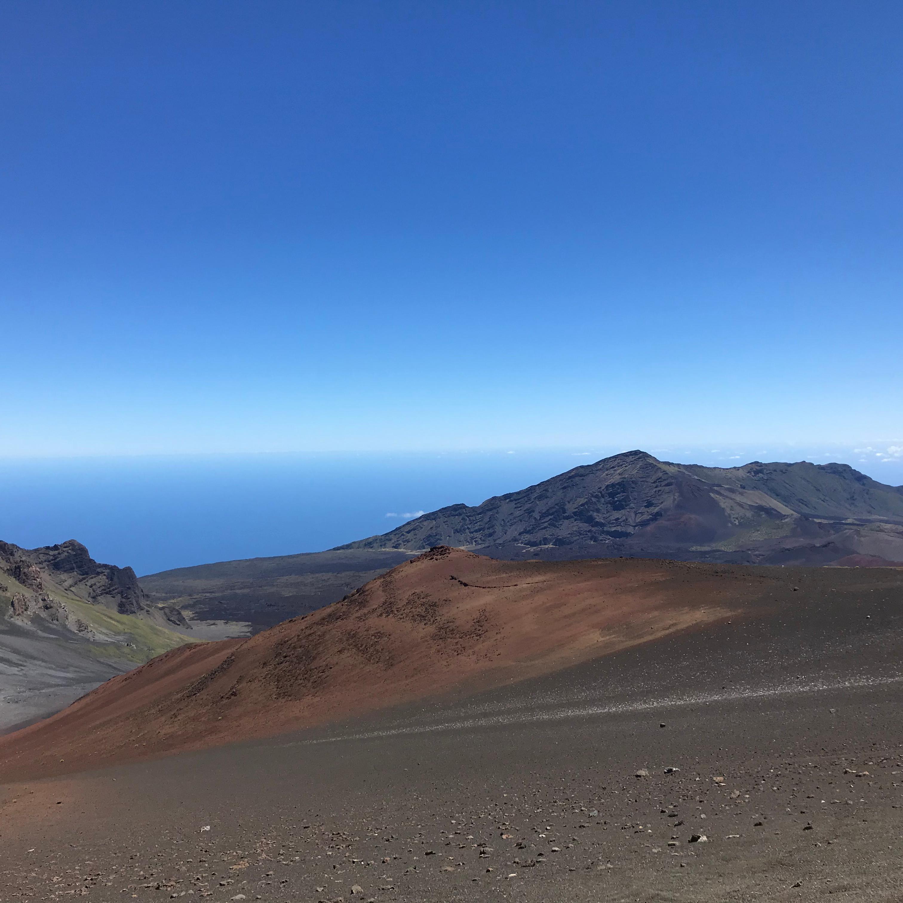 A trail leads down into a colorful volcanic valley.