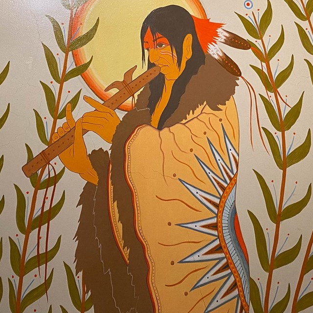 Mural of a Native American playing the flute
