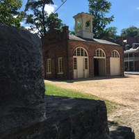 small brick building that is John Brown\'s Fort with other Lower Town buildings in the background
