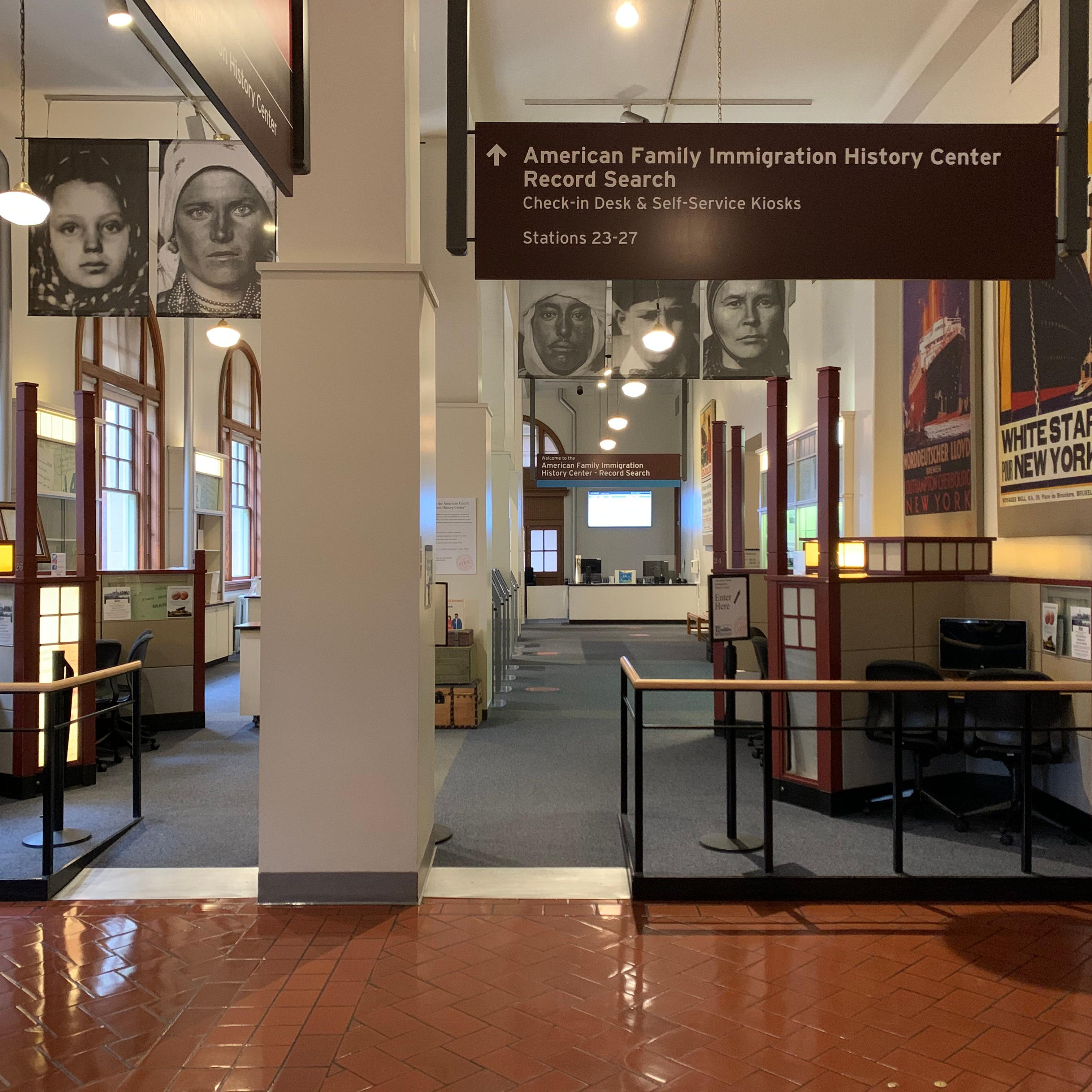 Separated desks with computer terminals in a large room 