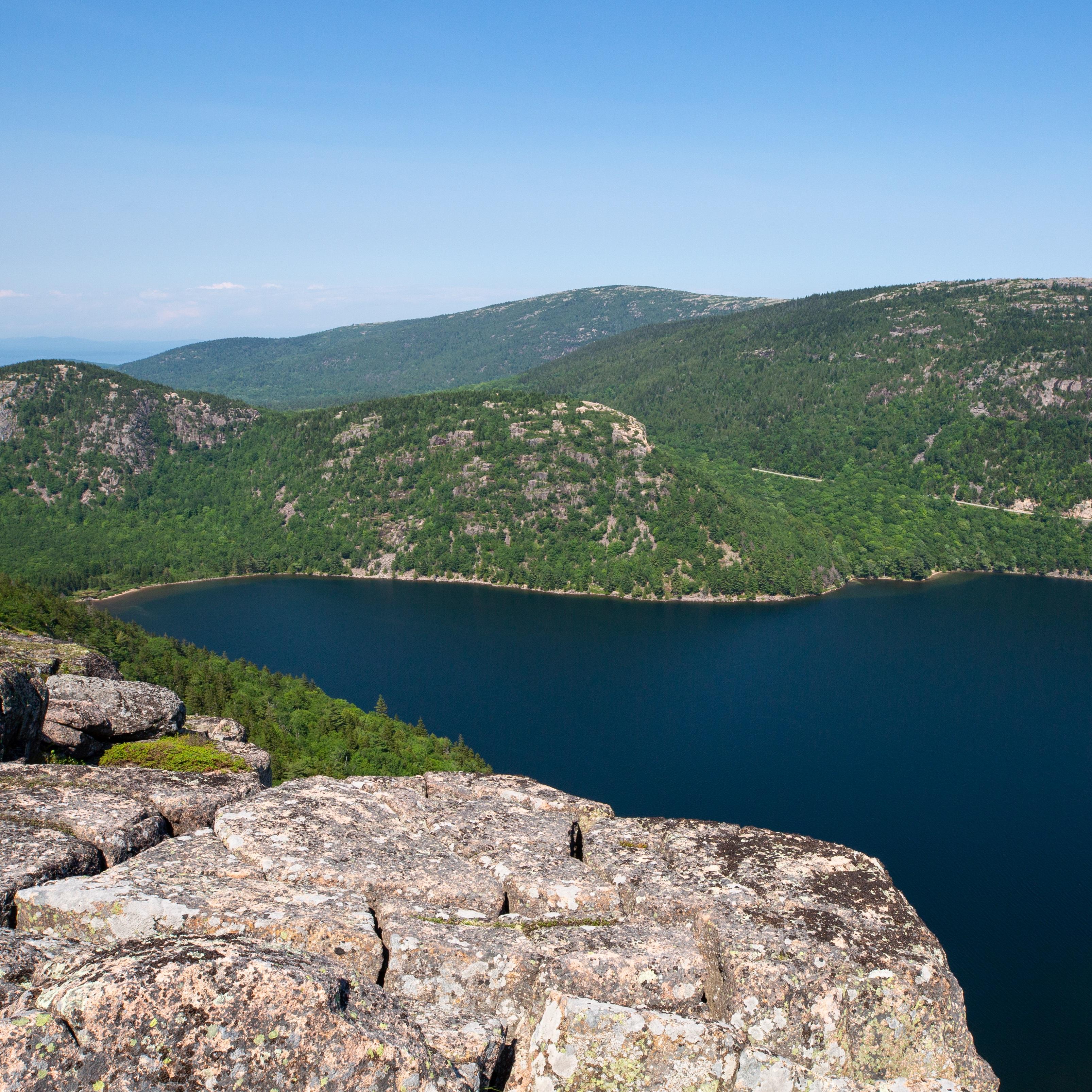 View from cliffs of forest and pond below