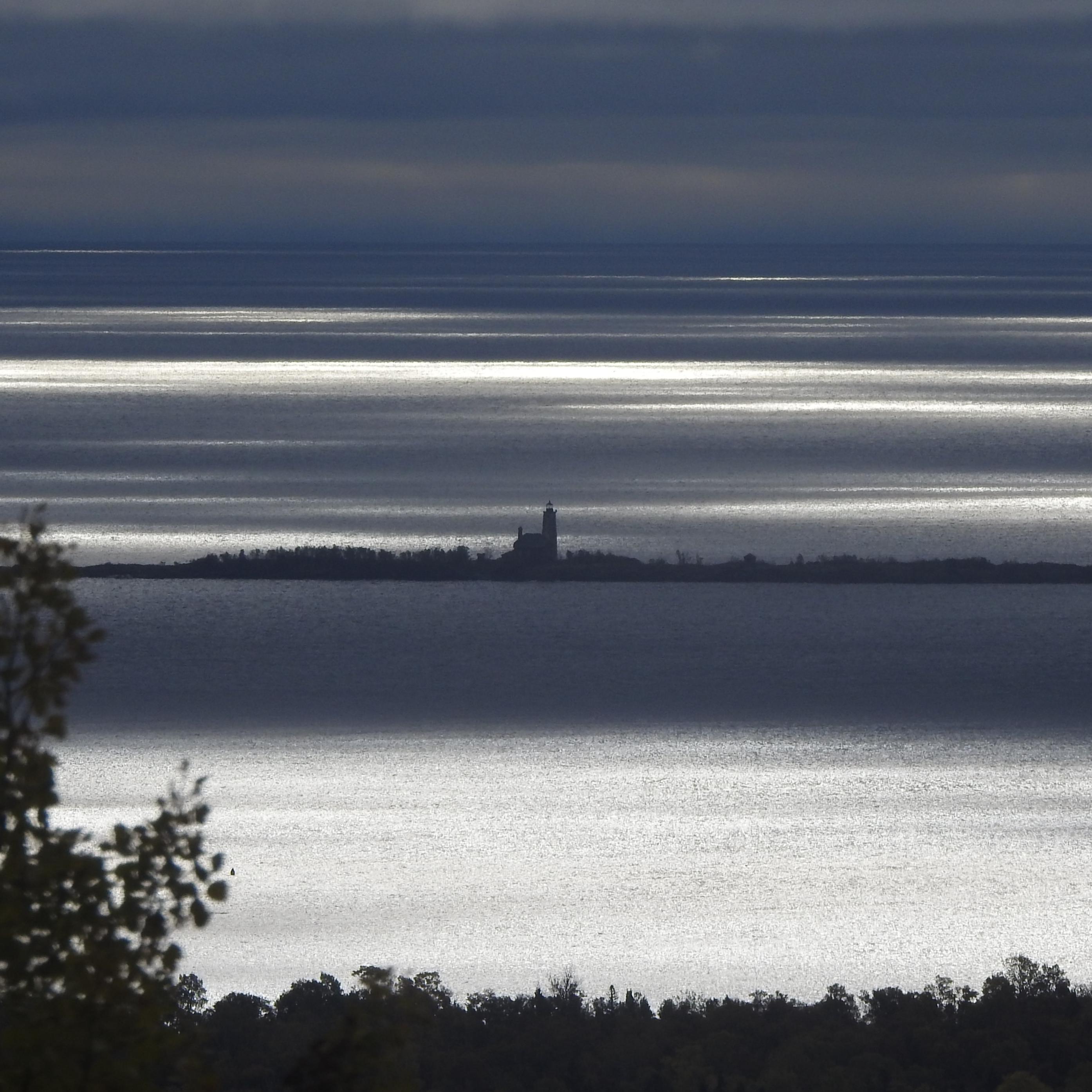 View of Lake, island, and lighthouse in the distance.