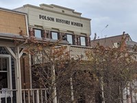 1900s historic building with wooden awning and second story windows.