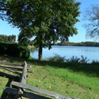 view of tidal river with split rail fence in foreground