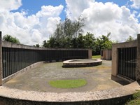 A series of curved walls. On the walls are plaques with names inscribed on them.