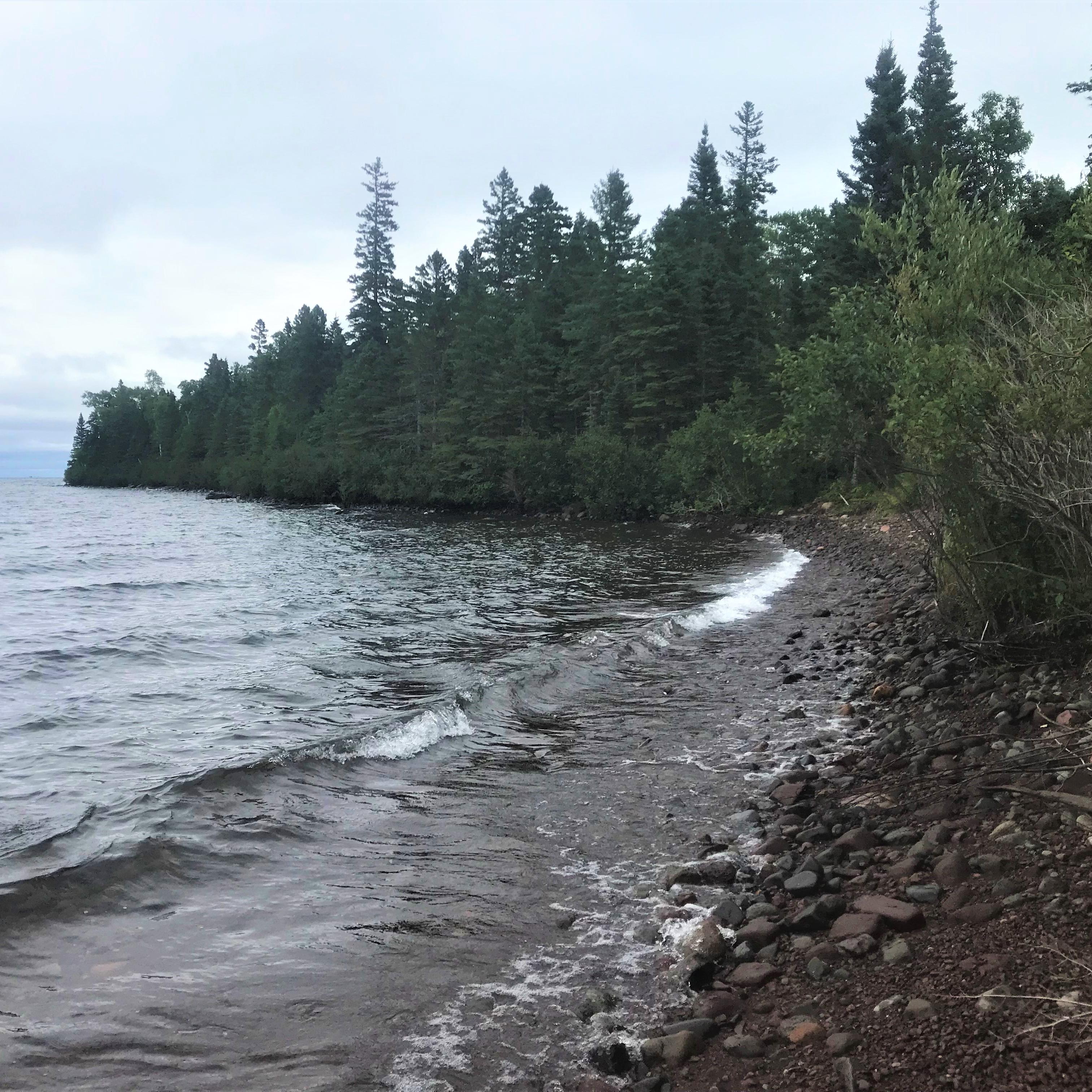 Forest and rocks make of a shoreline along Lake Superior. 