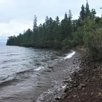 Forest and rocks make of a shoreline along Lake Superior. 