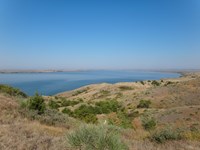 Grass upland with large river curving in the background