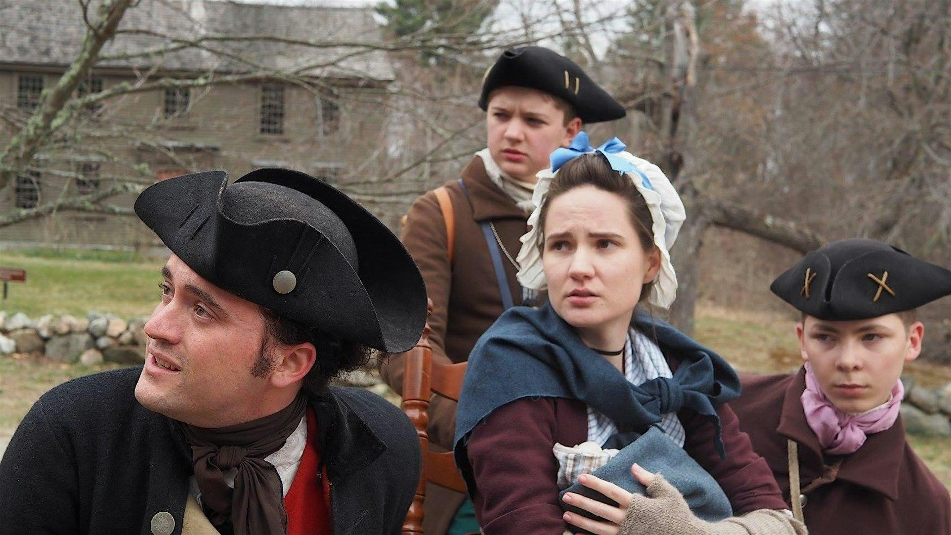 A man, a woman, and two children in Colonial attire