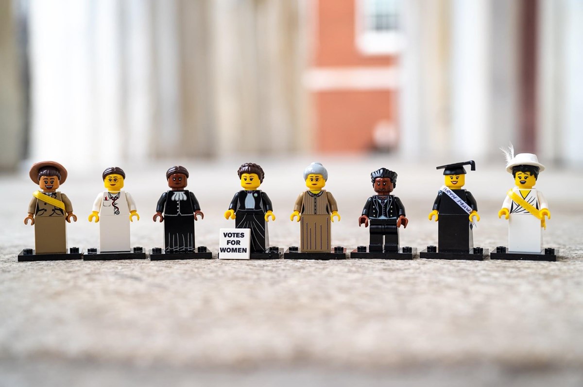 Eight LEGO figurines representing various individuals who fought for women's right to vote.