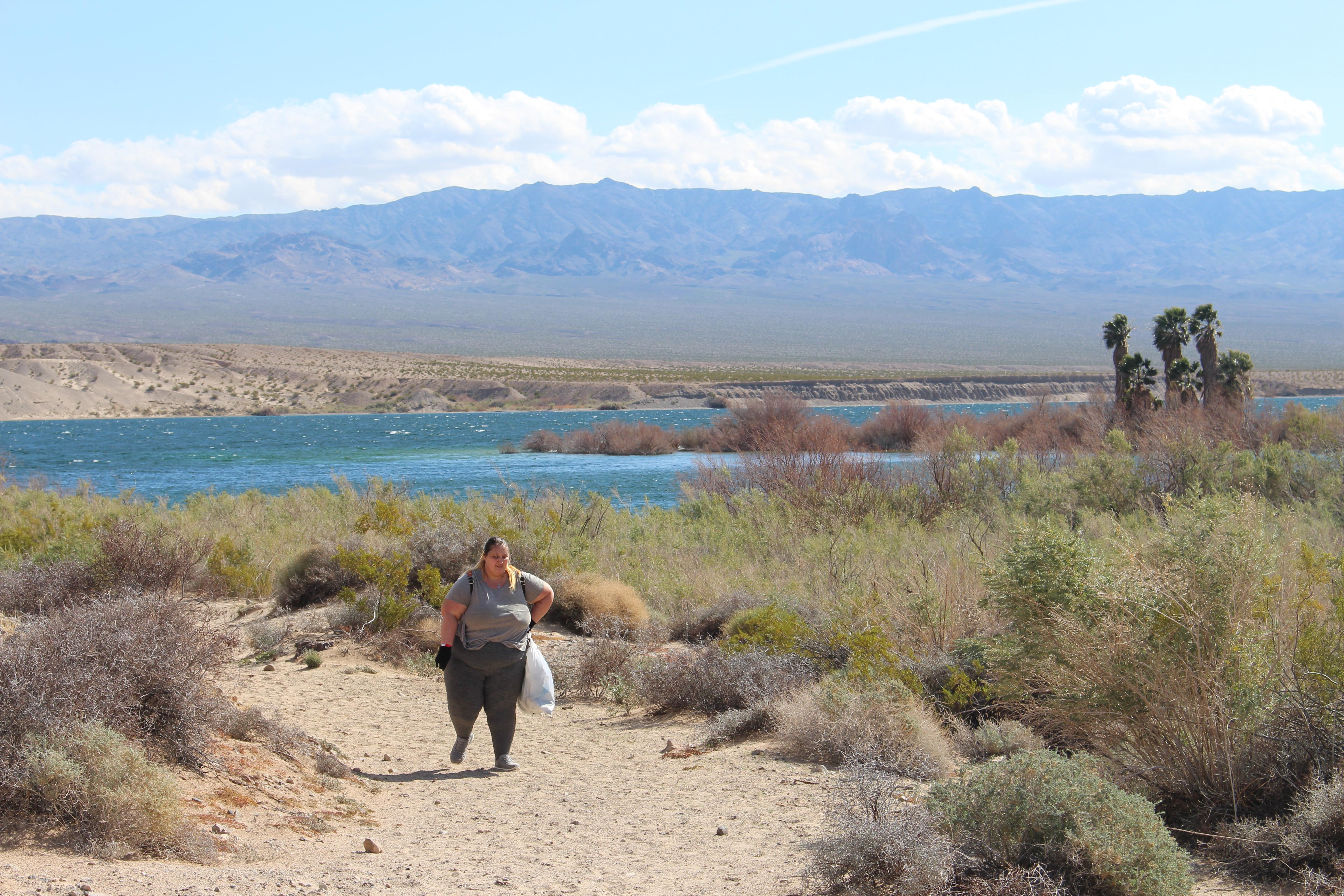 Volunteer removing trash from the shoreline