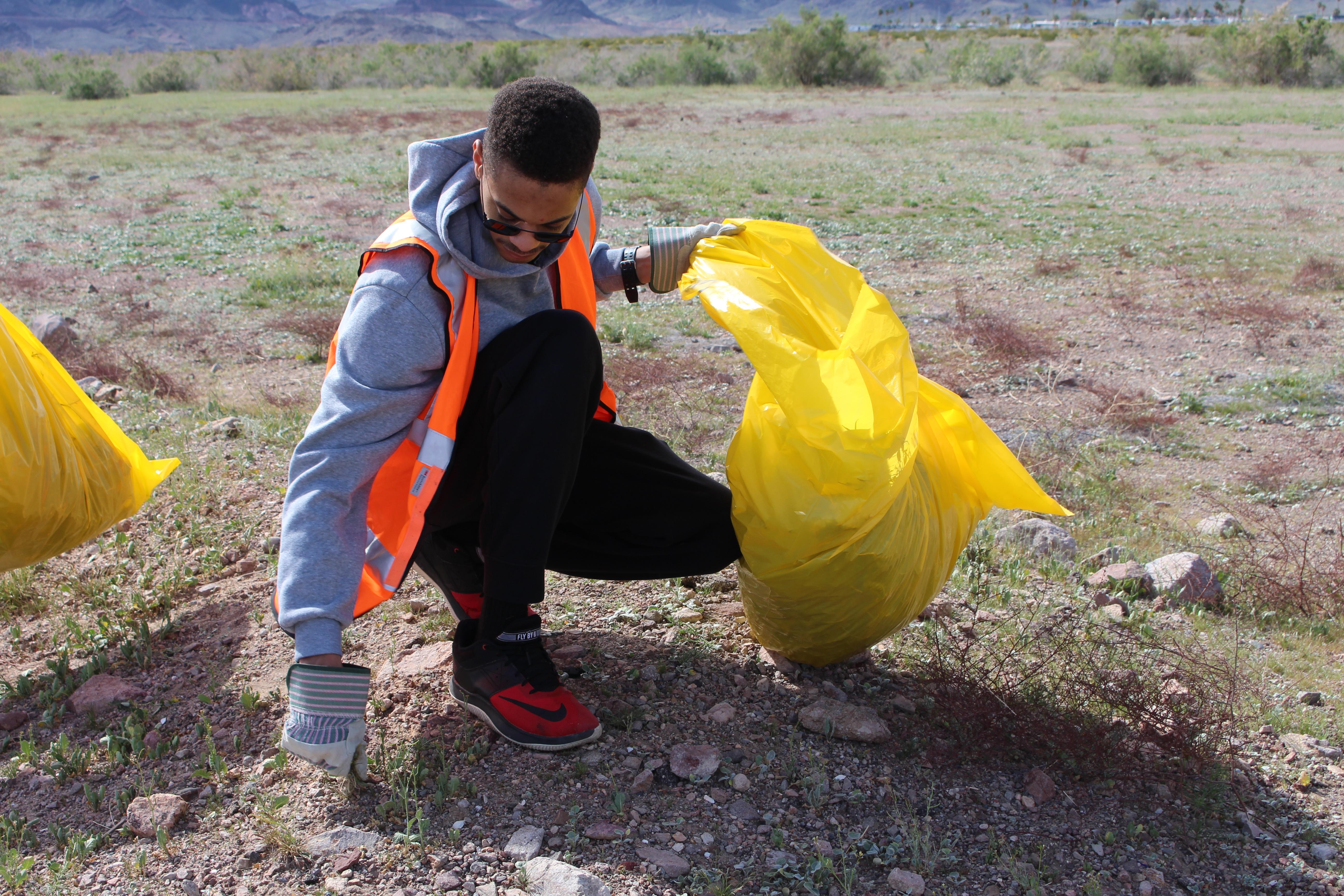 Volunteer hand pulling weeds