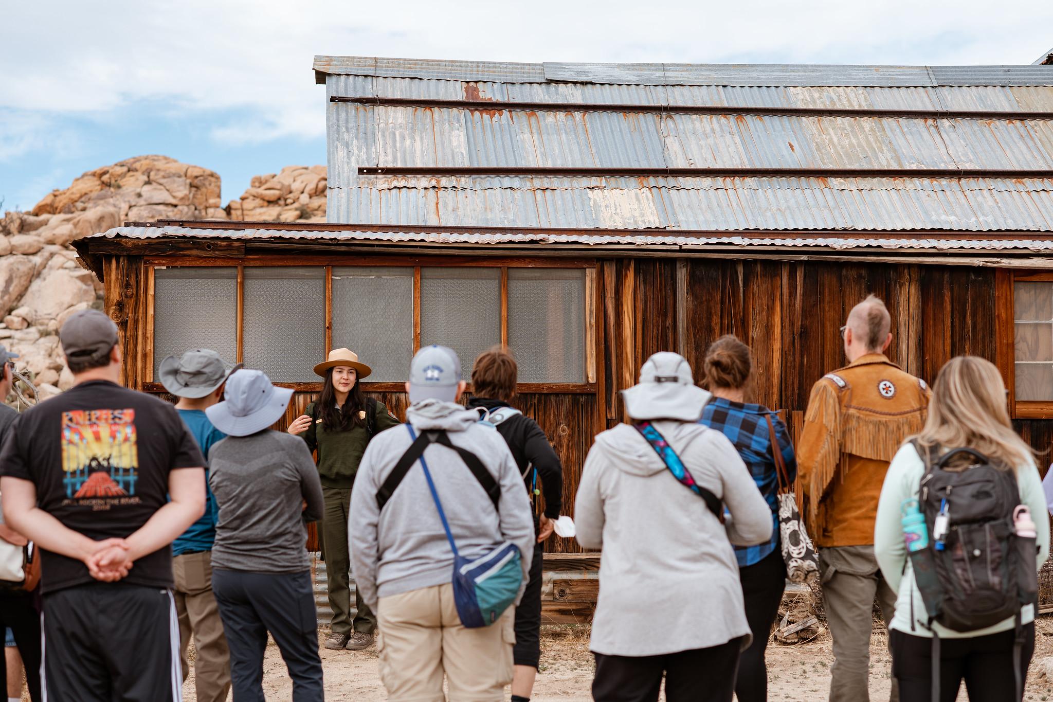A park ranger leads a tour in front of Keys Ranch.