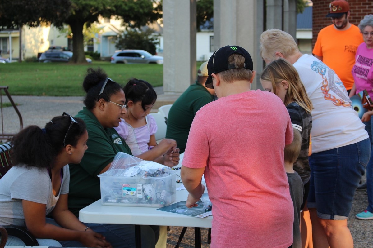 Volunteers helping Junior Rangers with an activity