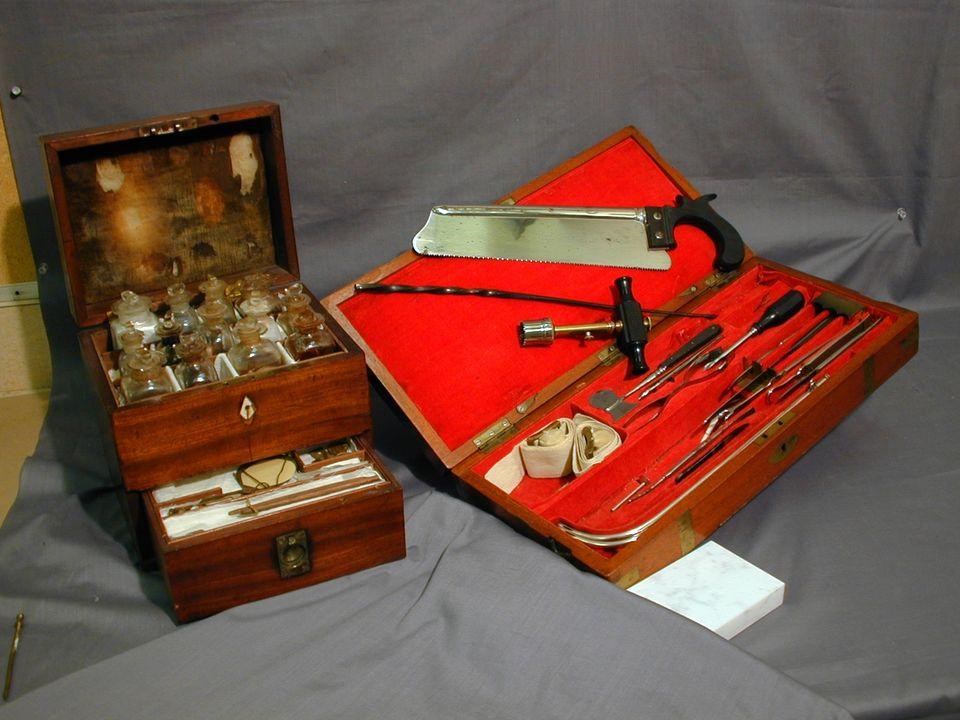 A wooden box with medical tools and bottles in it.